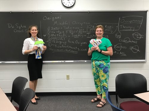 Sylvia and Co-teacher leading Origami class 